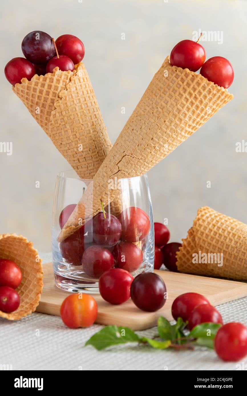 Prugne fresche in coni gelato, cibi dolci e salutari Foto Stock
