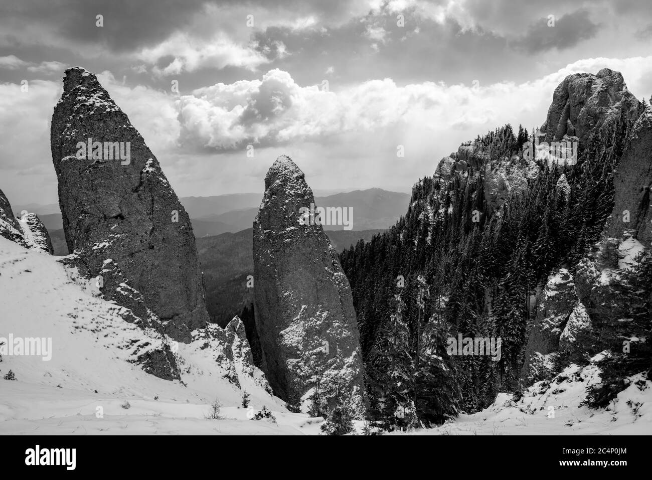 montagne rocciose piene di neve e villaggi nella valle Foto Stock