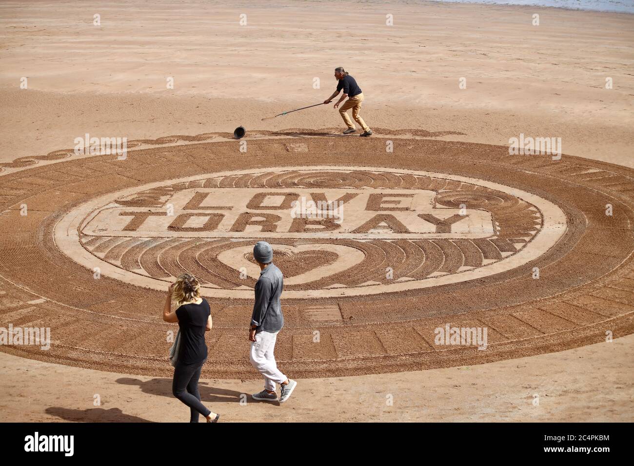 Torbay, Regno Unito. 28 luglio 2020. "Love Torbay" Beach art mentre Torquay si prepara ad aprire l'ospitalità il prossimo fine settimana. Artista Geoffrey Ward, aka SandyMan Credit: Julian Kemp/Alamy Live News Foto Stock