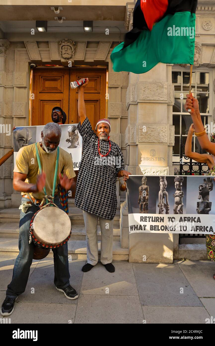 I manifestanti degli 'africani nella diaspora si riuniscono fuori da Christie's a Londra per chiedere il ritorno di manufatti africani 'saccheggiati'. Foto Stock