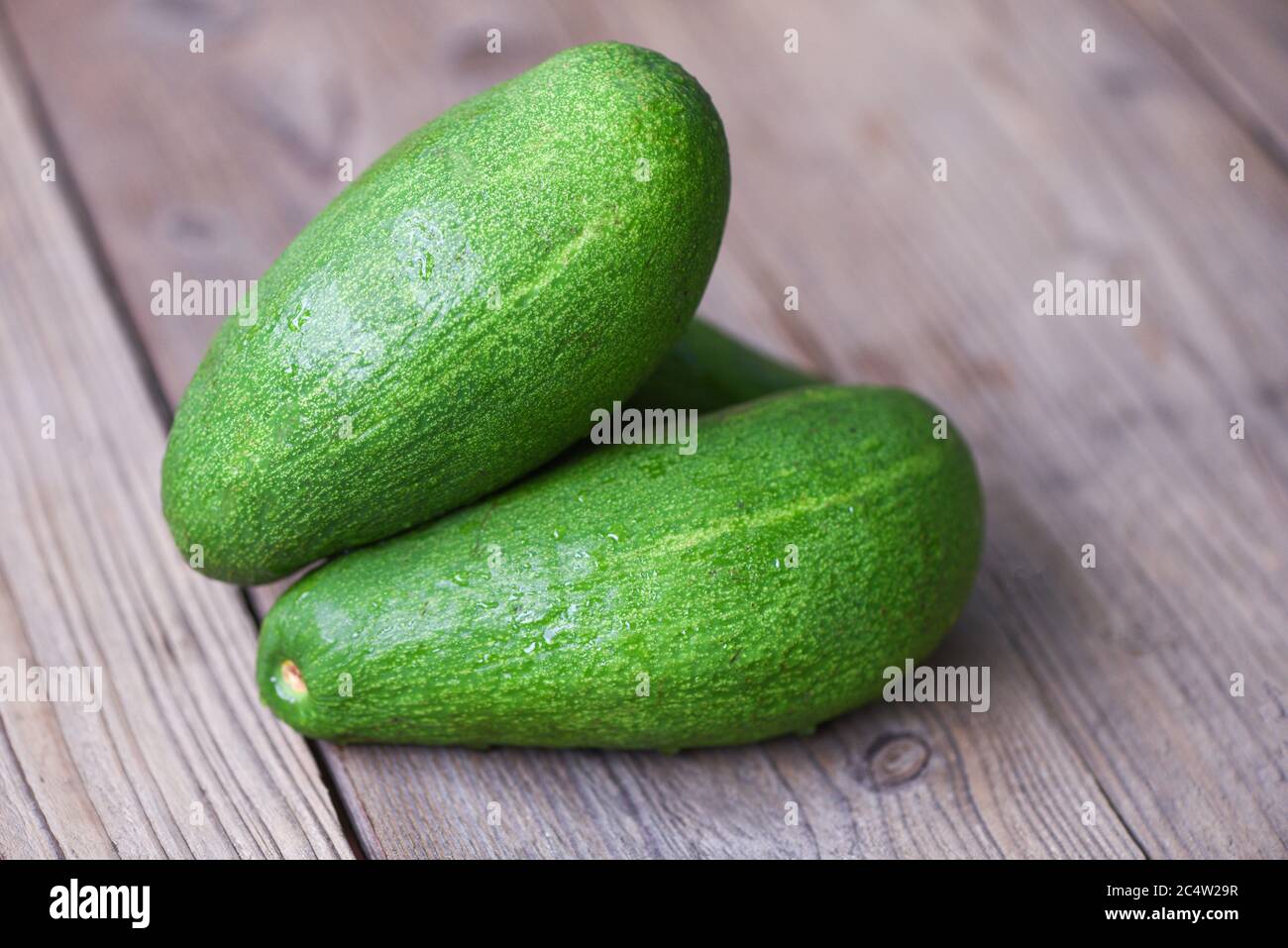 Fresh green avocado on the wooden table / Fruits healthy food concept Foto Stock