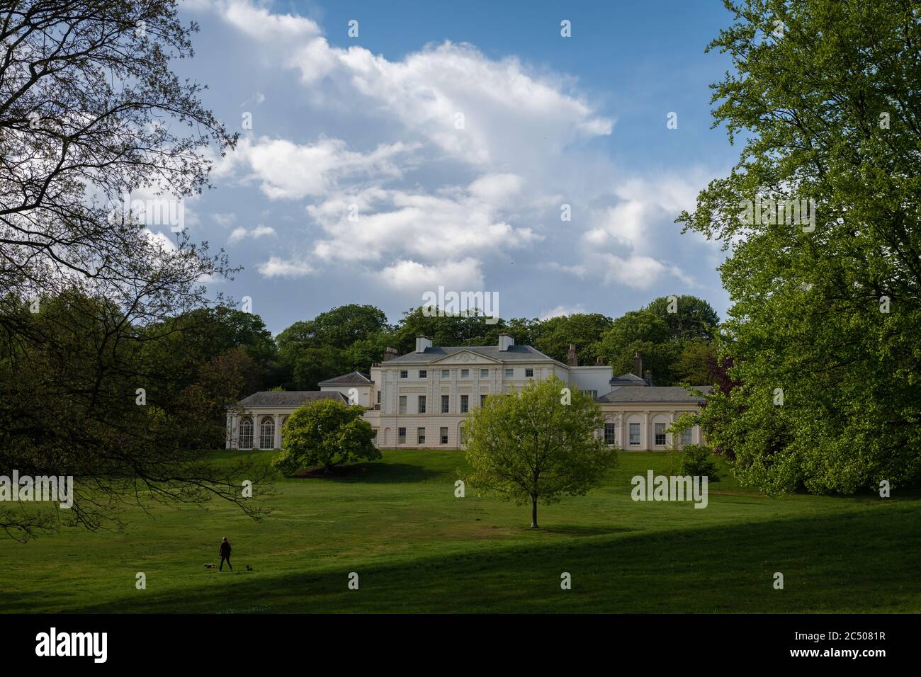 Kenwood House e i terreni circostanti in primavera con lussureggiante erba verde e alberi in una bella giornata con le nuvole blu cielo. Foto Stock