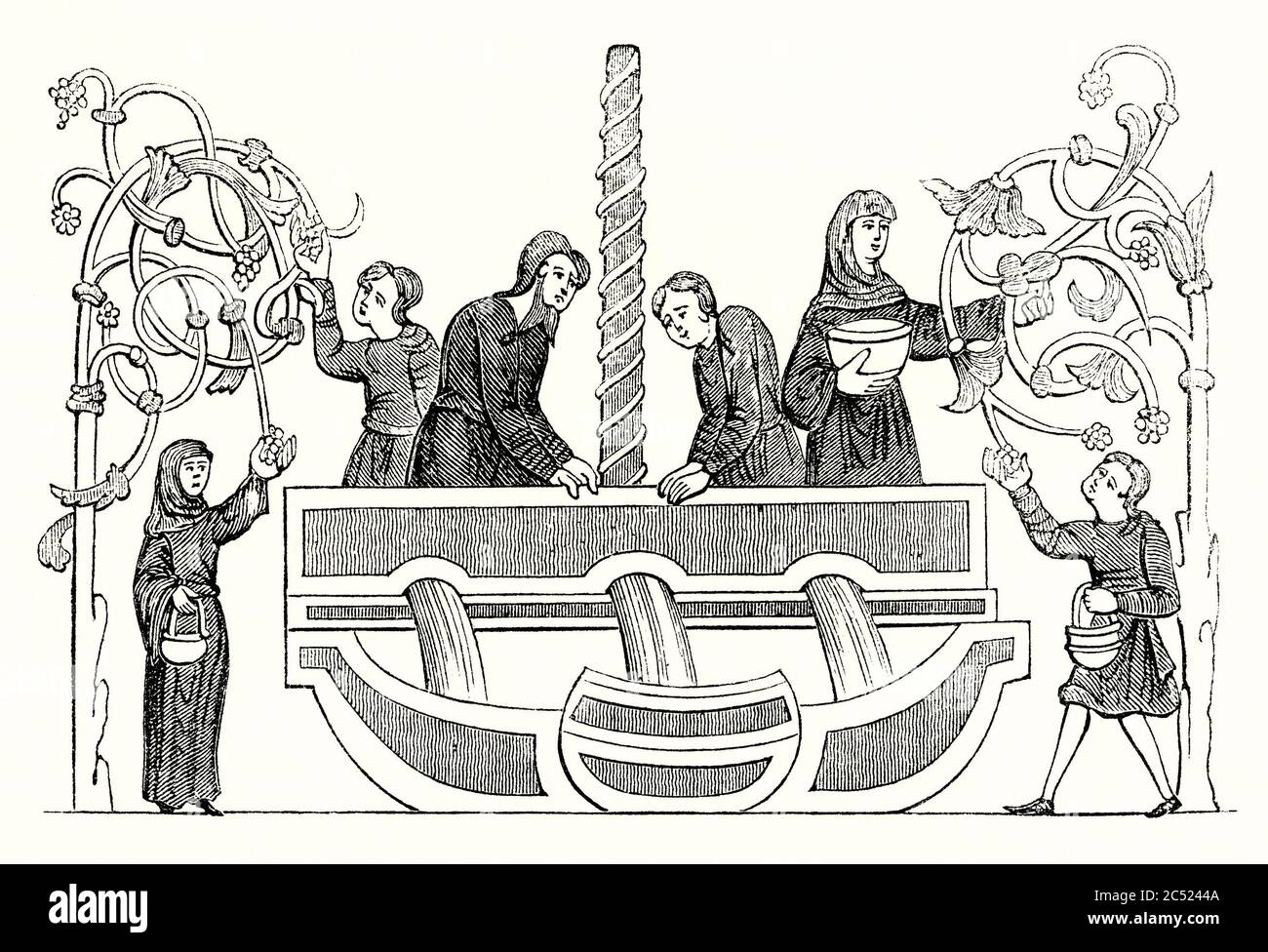 Una vecchia incisione che mostra la produzione del vino. La vinificazione era un'occupazione comune nel Medioevo anche nel Regno Unito. Qui si raccolgono grappoli di uve a sinistra e a destra. Gli uomini in un grande serbatoio calpestano le uve e il succo è visto fluire in contenitori o vasi sotto. Foto Stock