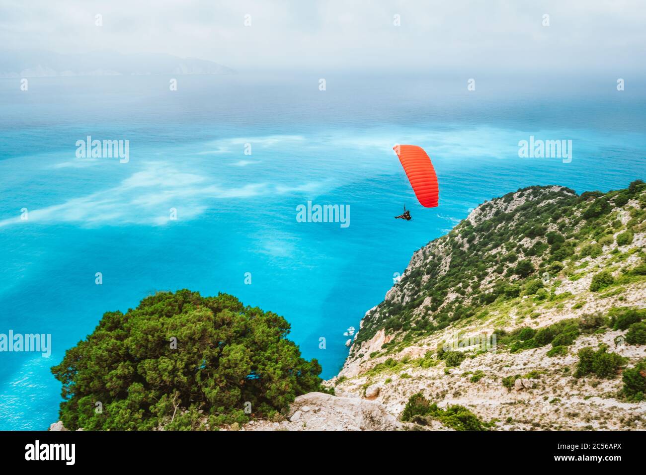Volo in parapendio sulla spiaggia di Myrtos. Isola di Cefalonia, Grecia. Attività hobby ricreativa. Foto Stock