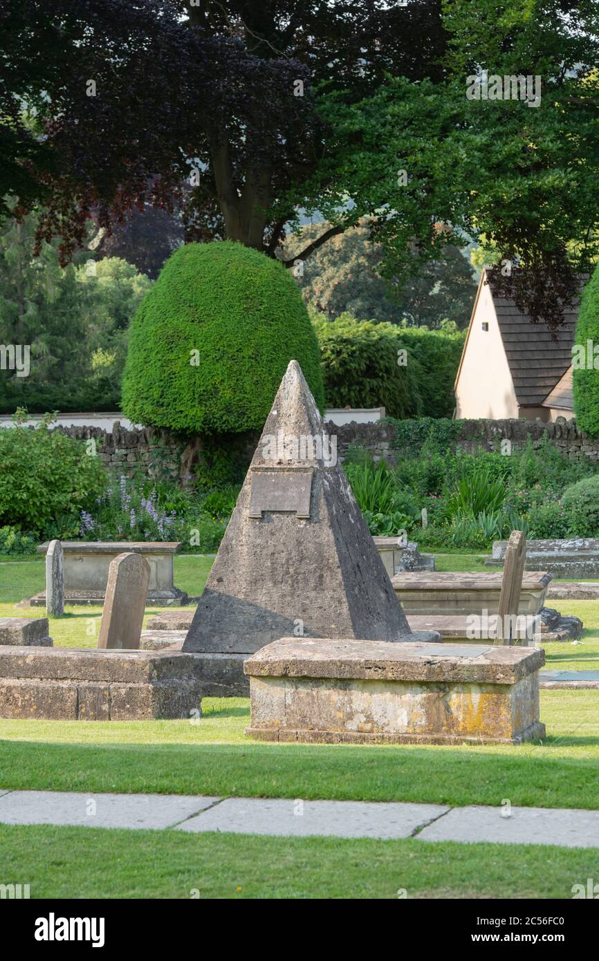 Tomba piramidale dello scalo John Bryan nel cortile di St Marys, la mattina presto. Painswick, Gloucestershire, Inghilterra Foto Stock