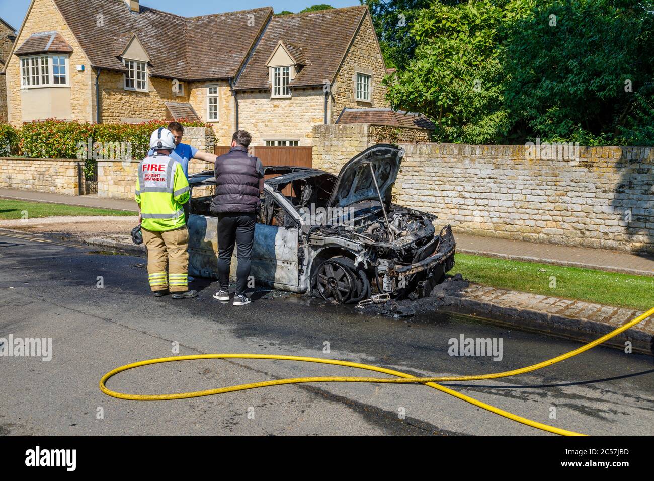 Un'auto completamente bruciata sul lato della strada in High Street, Chipping Campden, una piccola città di mercato nel Cotswolds in Gloucestershire Foto Stock