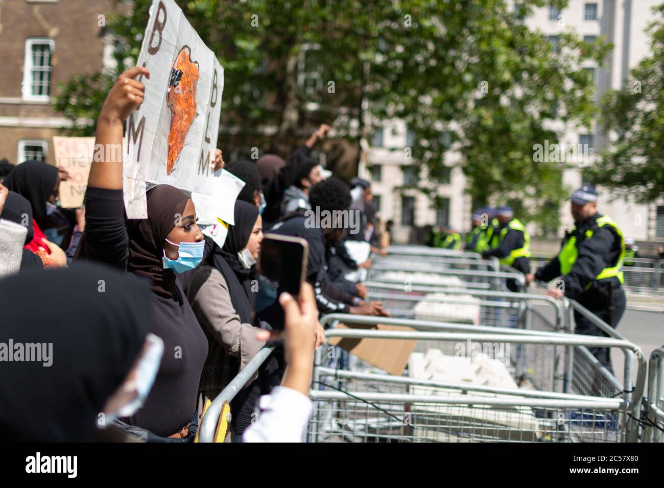 I manifestanti affrontano la polizia attraverso una barriera, Black Lives Matter dimostration, Downing Street, Londra, 27 giugno 2020 Foto Stock