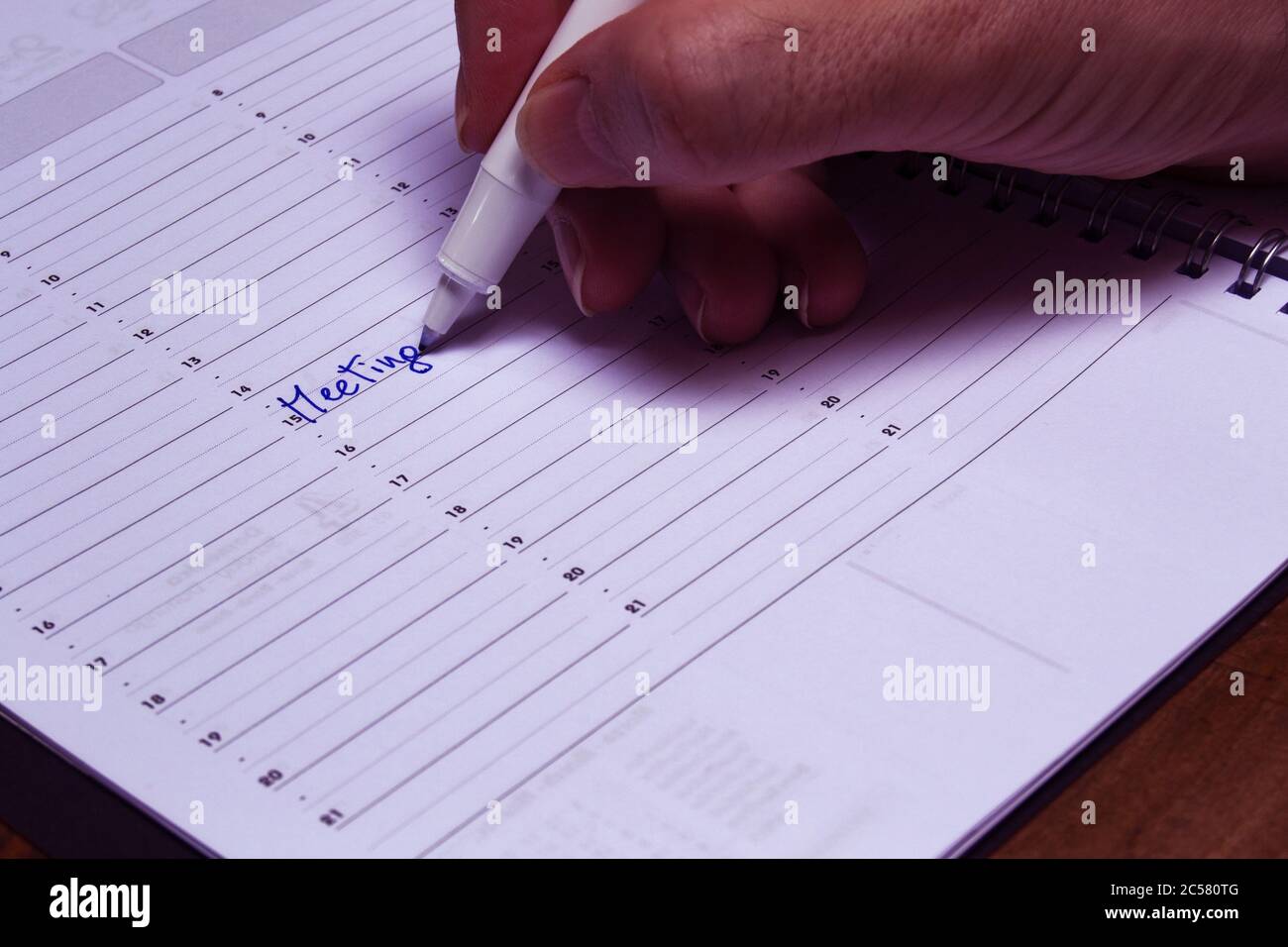 pianificazione del tempo di riunione su un blocco note per fissare una riunione aziendale. concetto per le aziende, applicazioni di lavoro Foto Stock