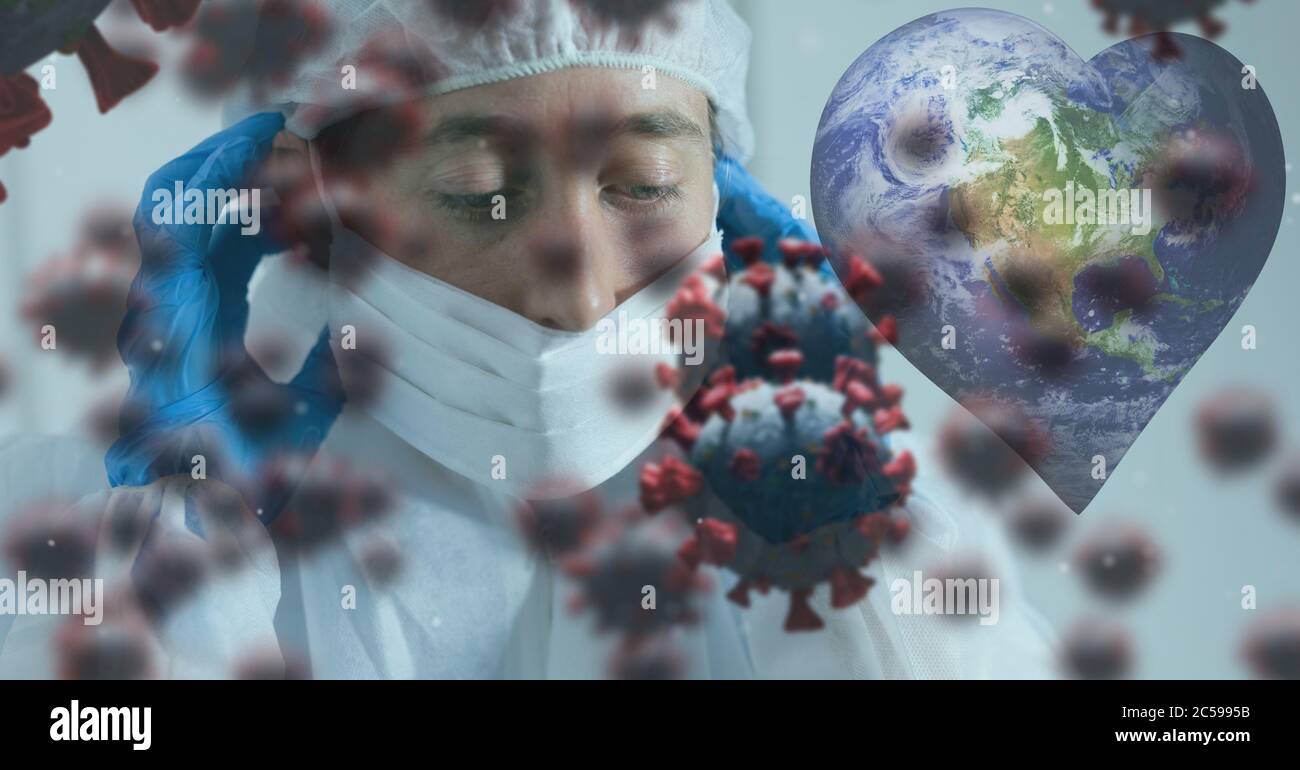 Cellule Covid-19 e globo a forma di cuore contro il medico che indossa la maschera facciale Foto Stock
