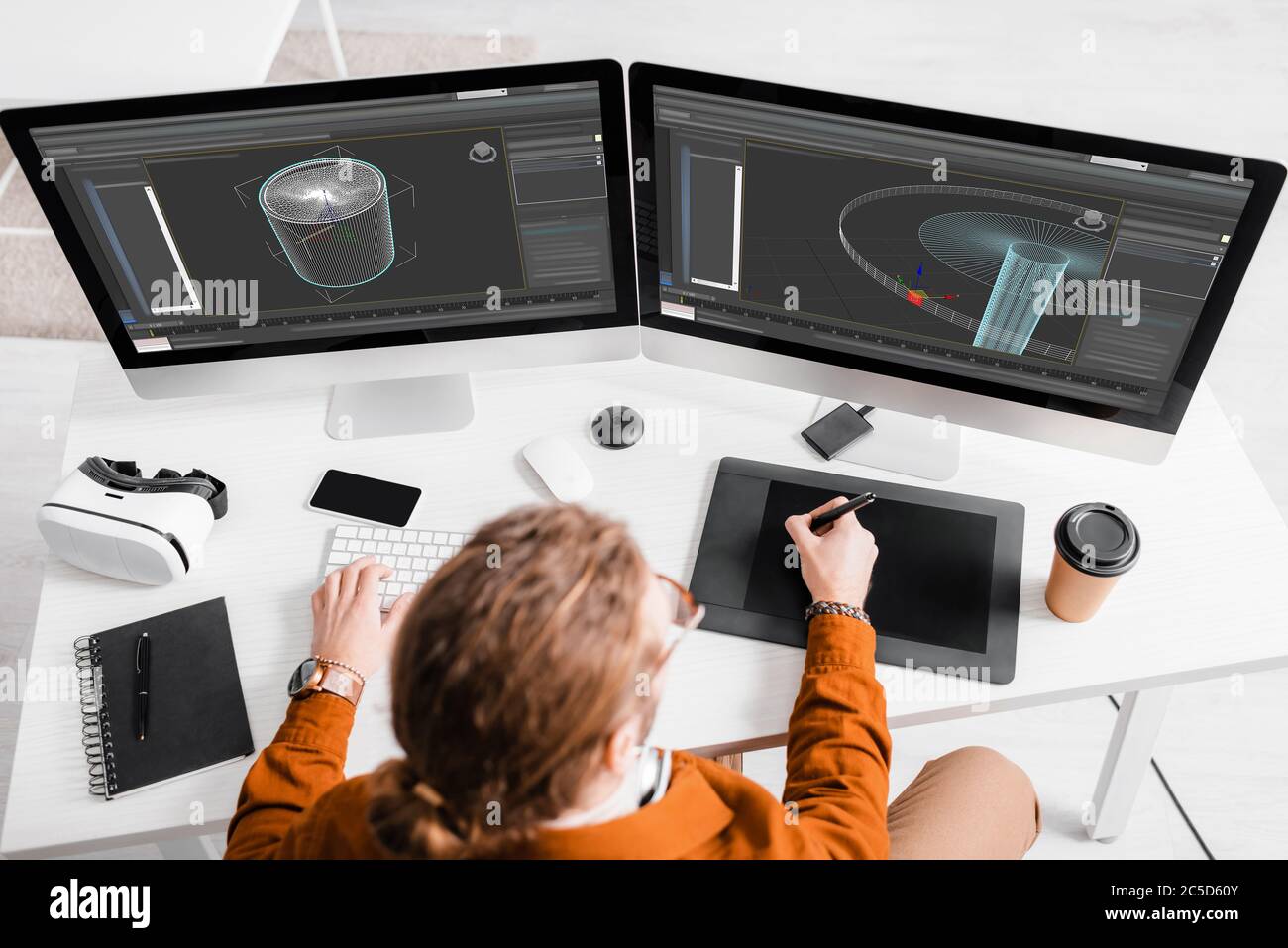 Vista dall'alto dell'artista 3d utilizzando tablet grafici e computer mentre si lavora su un progetto 3d al tavolo Foto Stock