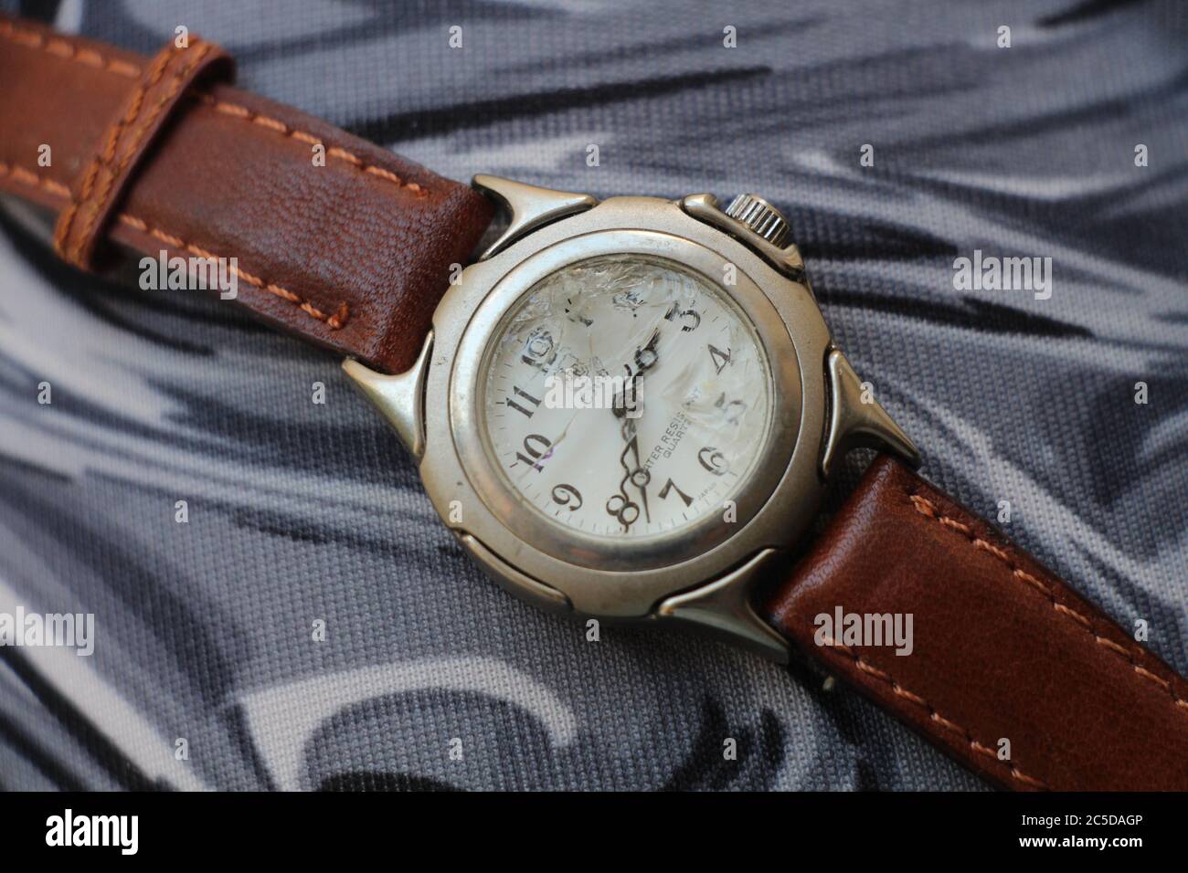 Un orologio da polso rotto - c'è un buco attraverso il vetro, ci sono molte  fessure Foto stock - Alamy