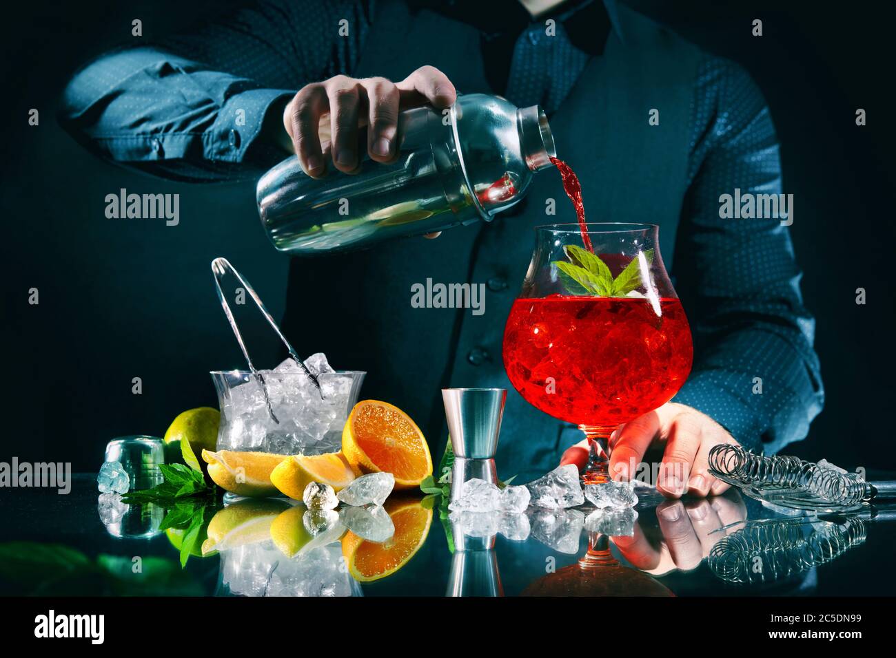 Il barman sta facendo un cocktail arancione campari al night club Foto Stock