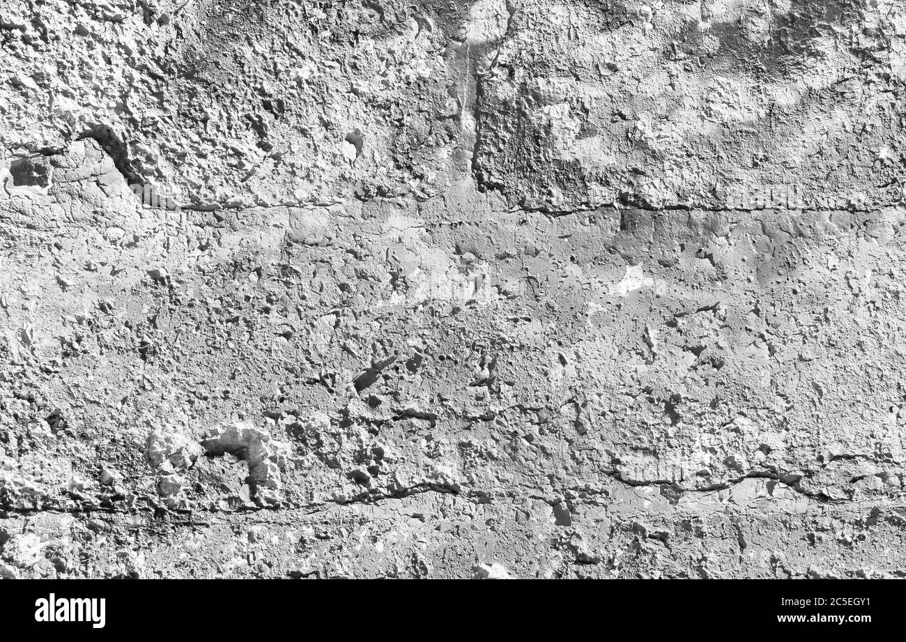 Tessitura di fondo di parete di calcestruzzo, intonaco ruvido o stucco. Parete di spellatura grunge di vecchio edificio, superficie grigio vintage con texture intemperie, abstra Foto Stock
