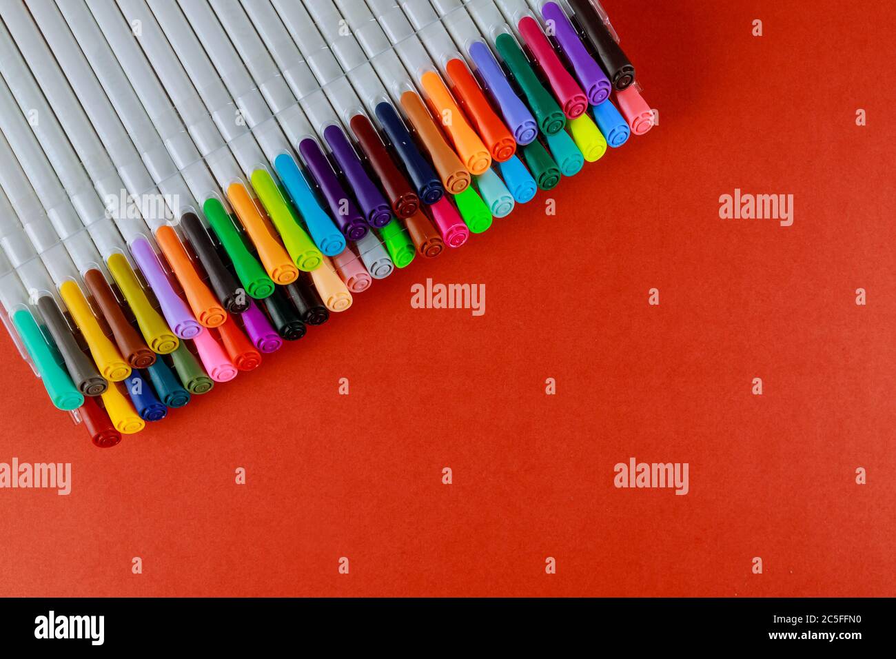 Set di colorate pennello Acquerelli penne sfondo rosso forniture scolastiche Foto Stock