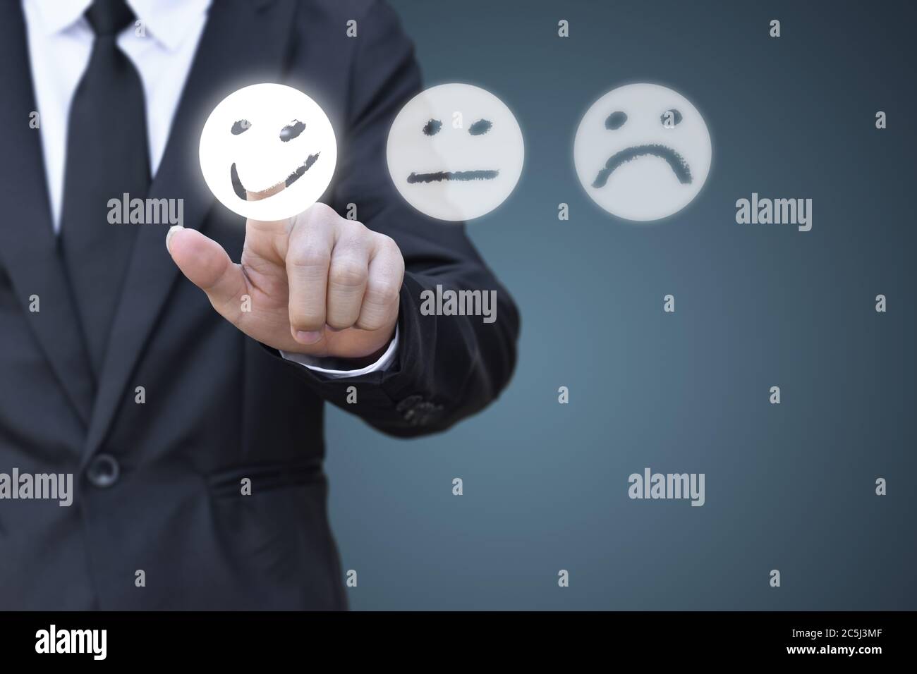 Uomo d'affari premendo l'icona del volto smiley sullo schermo virtuale. Concetto di valutazione della soddisfazione e feedback. Foto Stock