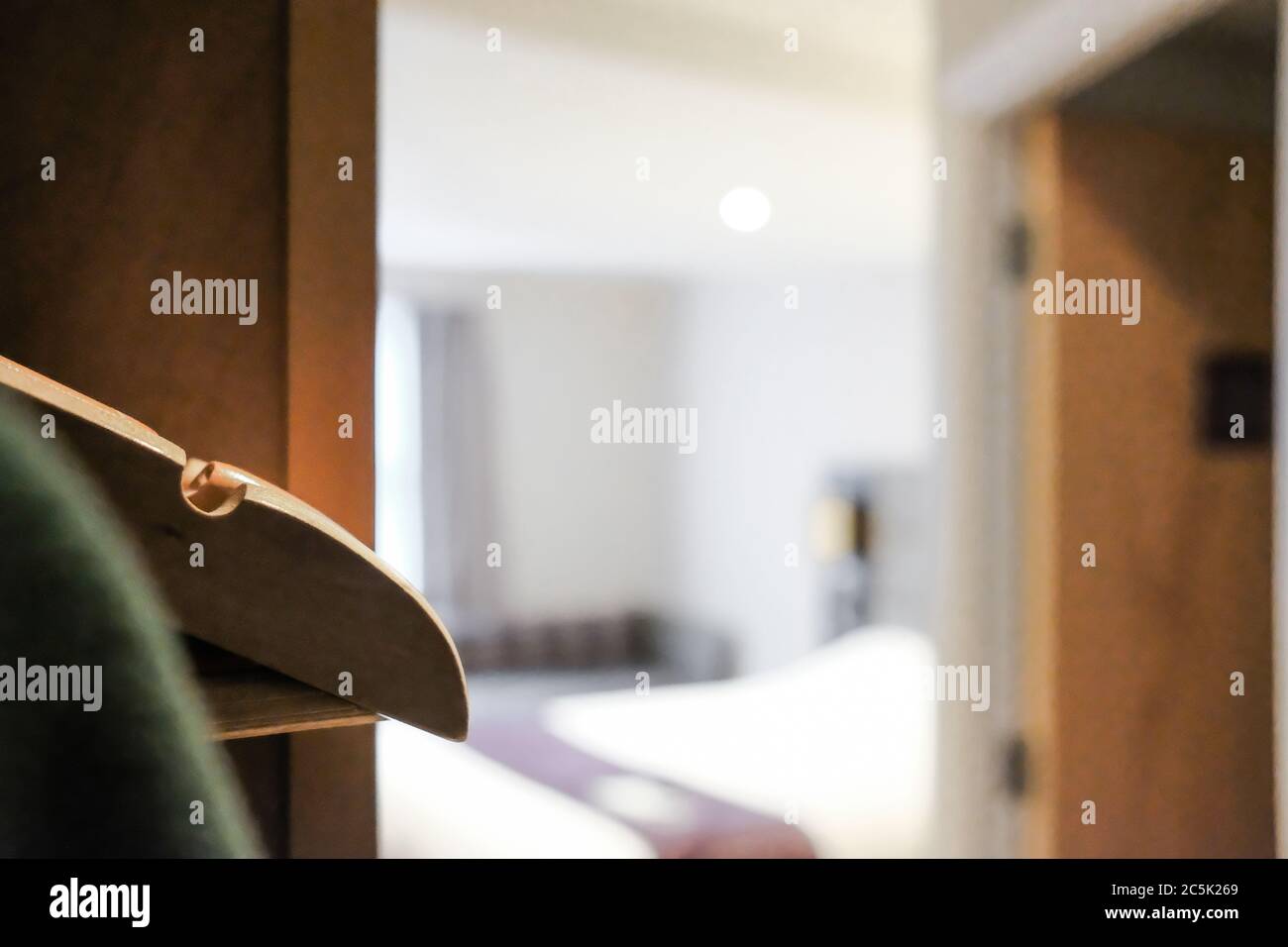 Il punto focale di un set di appendiabiti in legno visto in una sezione guardaroba in una moderna camera d'hotel a prezzi premium. Foto Stock