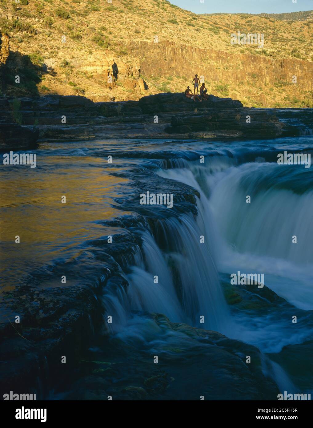 Fort Apache Indian Reservation AZ / JUNE Apache Youth posa per una fotografia sul fiume Gushing Salt River vicino all'incrocio con l'autostrada 77. Foto Stock