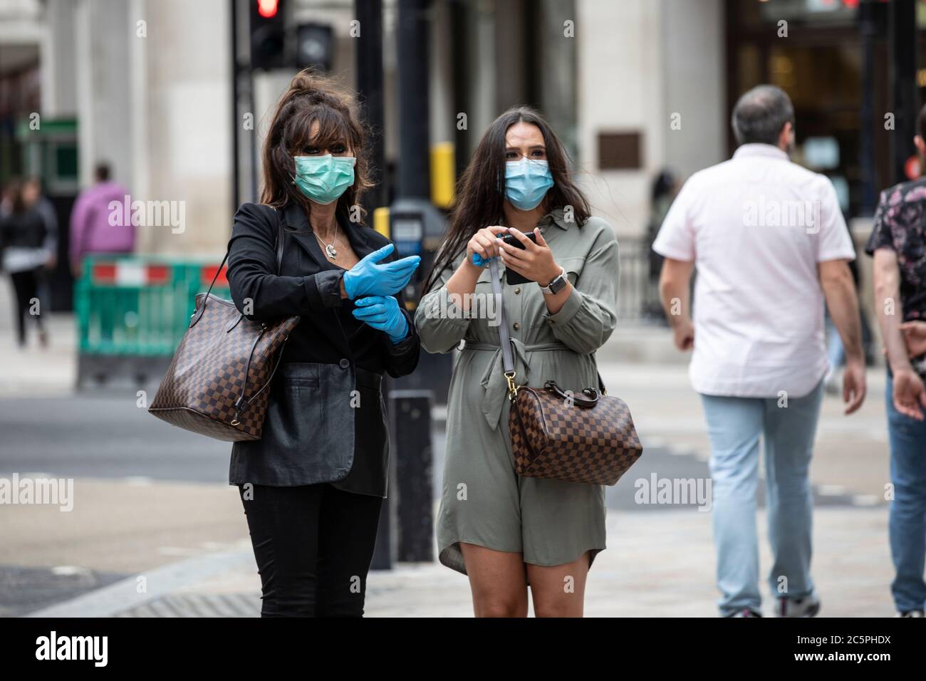 La distanza sociale è osservata da acquirenti pedonali a Oxford Circus, West End, Central London, England, UK Foto Stock