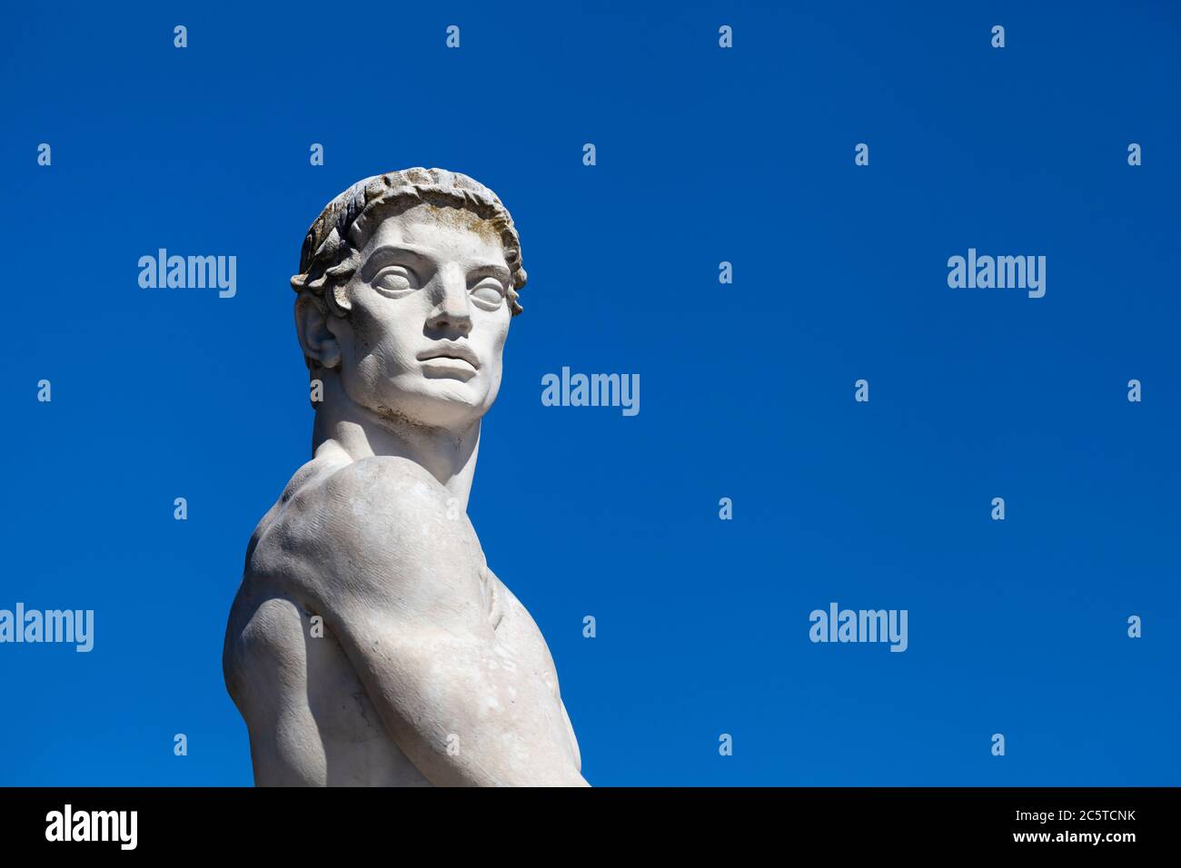 Atleta statua in marmo ritratto contro cielo blu - luce solare Foto Stock