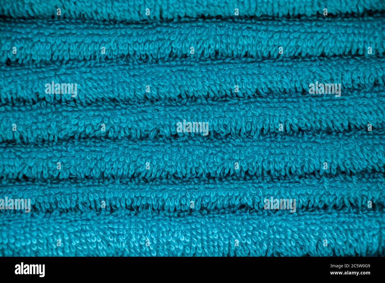 Texture di spugna blu primo piano asciugamano. Una pila di accessori per bagno morbidi. Foto Stock