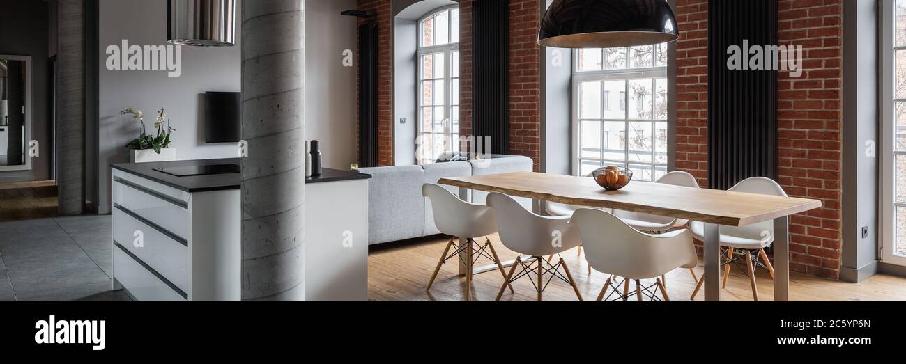 Interno casa con grandi finestre e lungo tavolo da pranzo in cucina, panorama Foto Stock