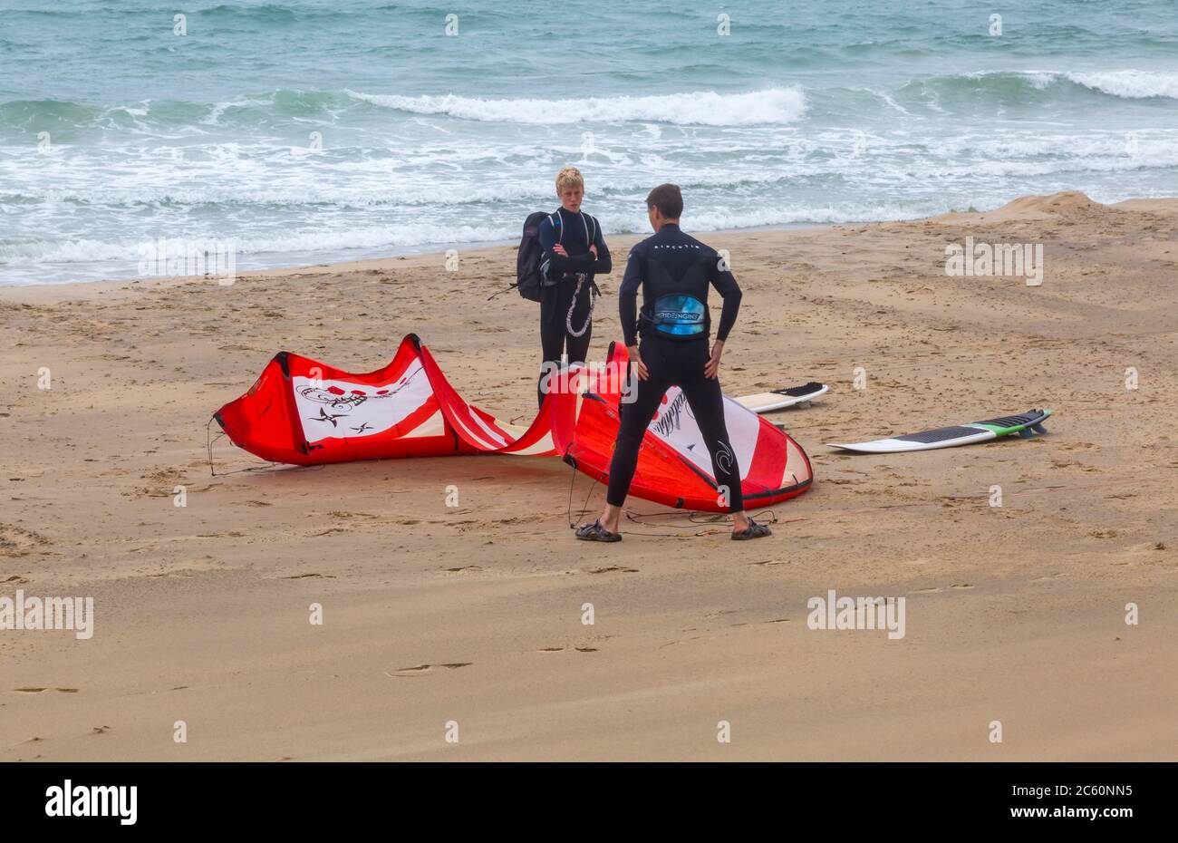 Kite surfers preparandosi per andare kite surf a Bournemouth, Dorset UK sulla giornata ventosa drizzle nel mese di luglio - kitesurfers kite surfer kitesurfer kitesurf Foto Stock