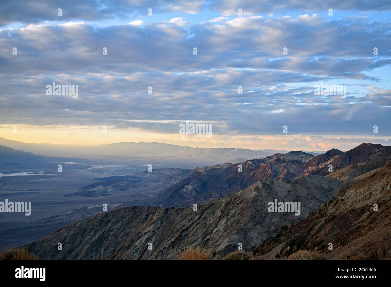 Tramonto a Dantes Vista sopra la Valle della morte, California. Guardando a nord verso Furnace Creek. Il sole sta rompendo attraverso le nuvole mentre comincia a regolare. Foto Stock