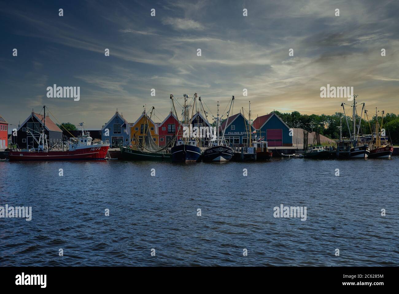 Europa Paesi Bassi Tour attraverso i canali, magazzini colorati nel piccolo porto olandese a Zoutkamp Foto Stock