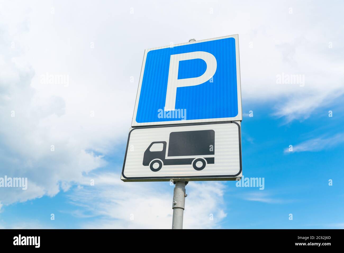 Cartello parcheggio camion contro il cielo blu. Cartello blu del parcheggio. Carrello nero su piastra bianca. Foto di alta qualità Foto Stock