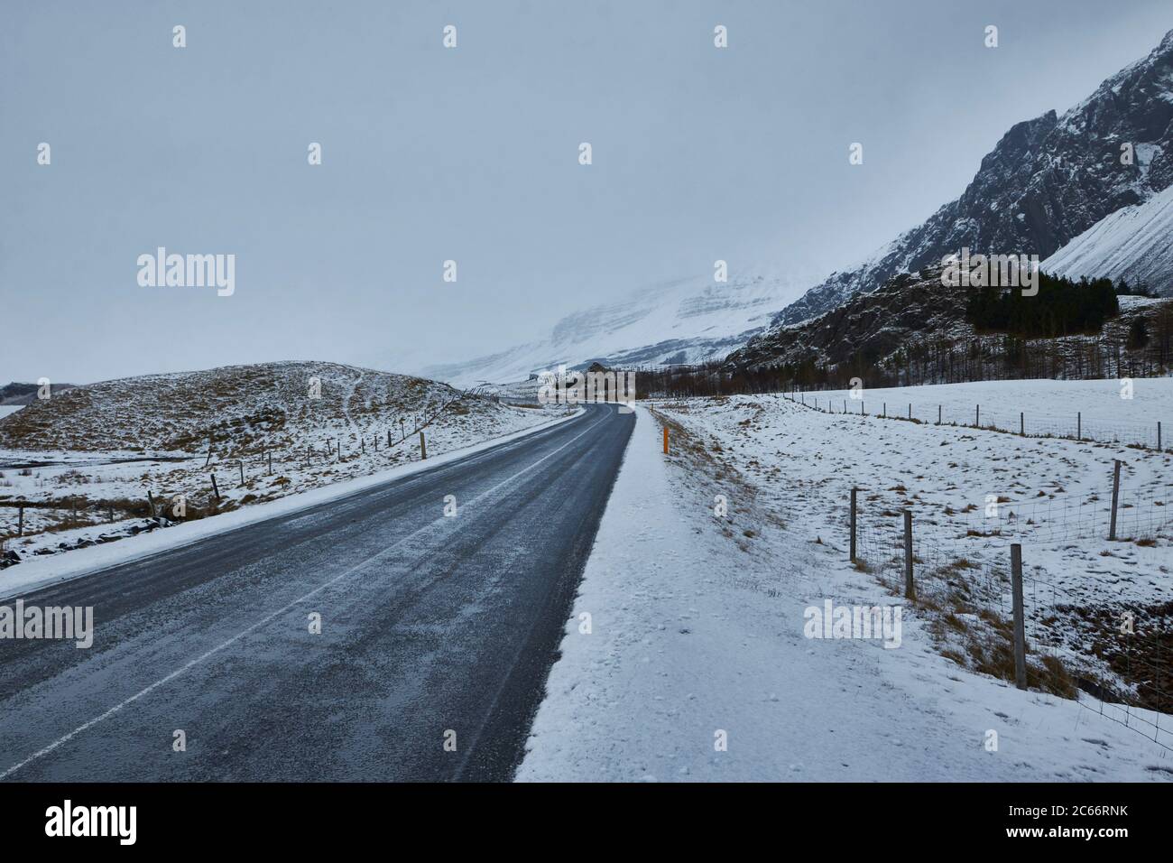 strada attraverso le montagne islandesi coperte di neve, fiordi orientali, fengeline Foto Stock