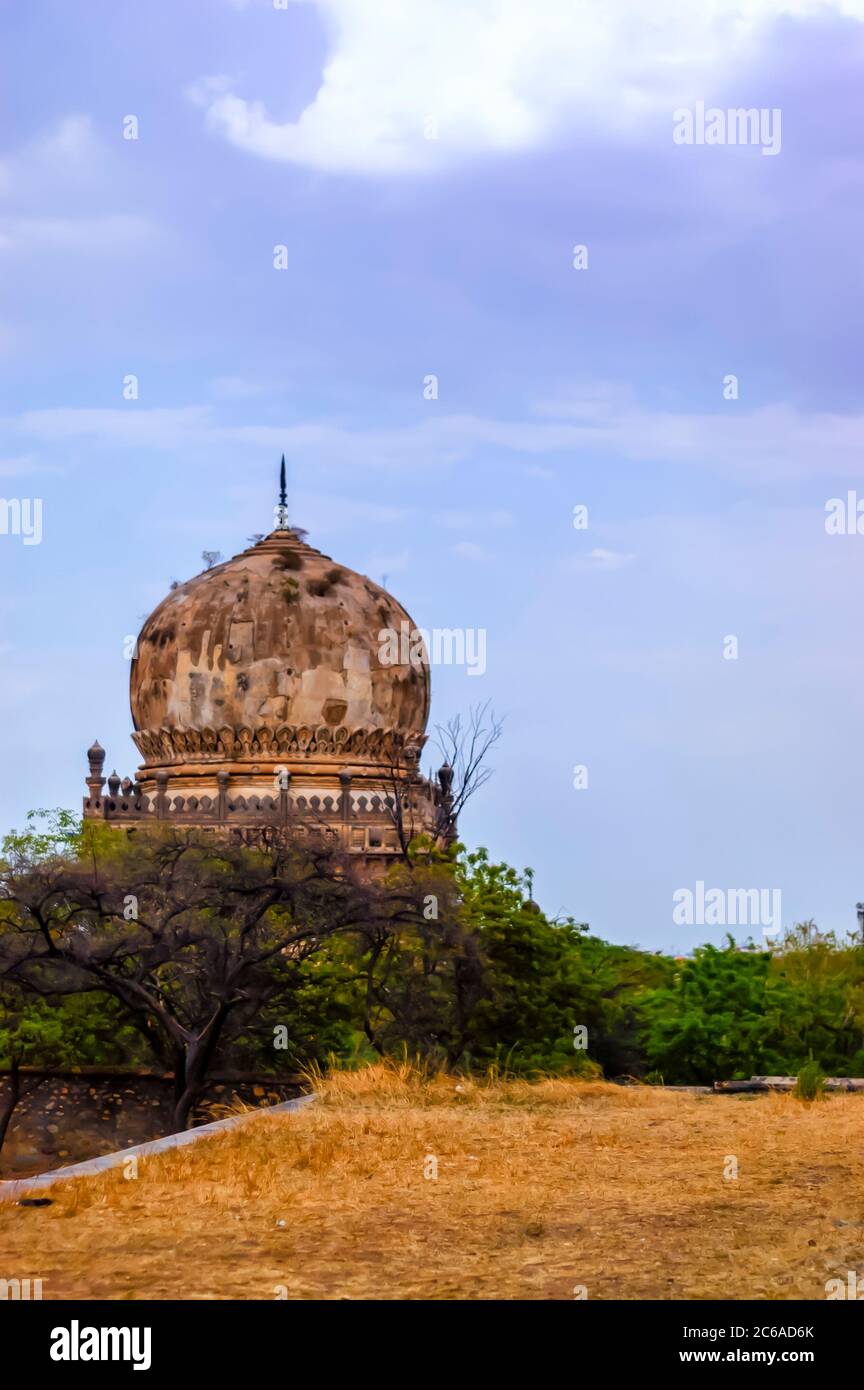 Una struttura a cupola intemperata di una tomba all'interno del complesso della tomba Qutb Shahi/Qutub Shahi a Ibrahim Bagh, Hyderabad, Telangana, India. Foto Stock