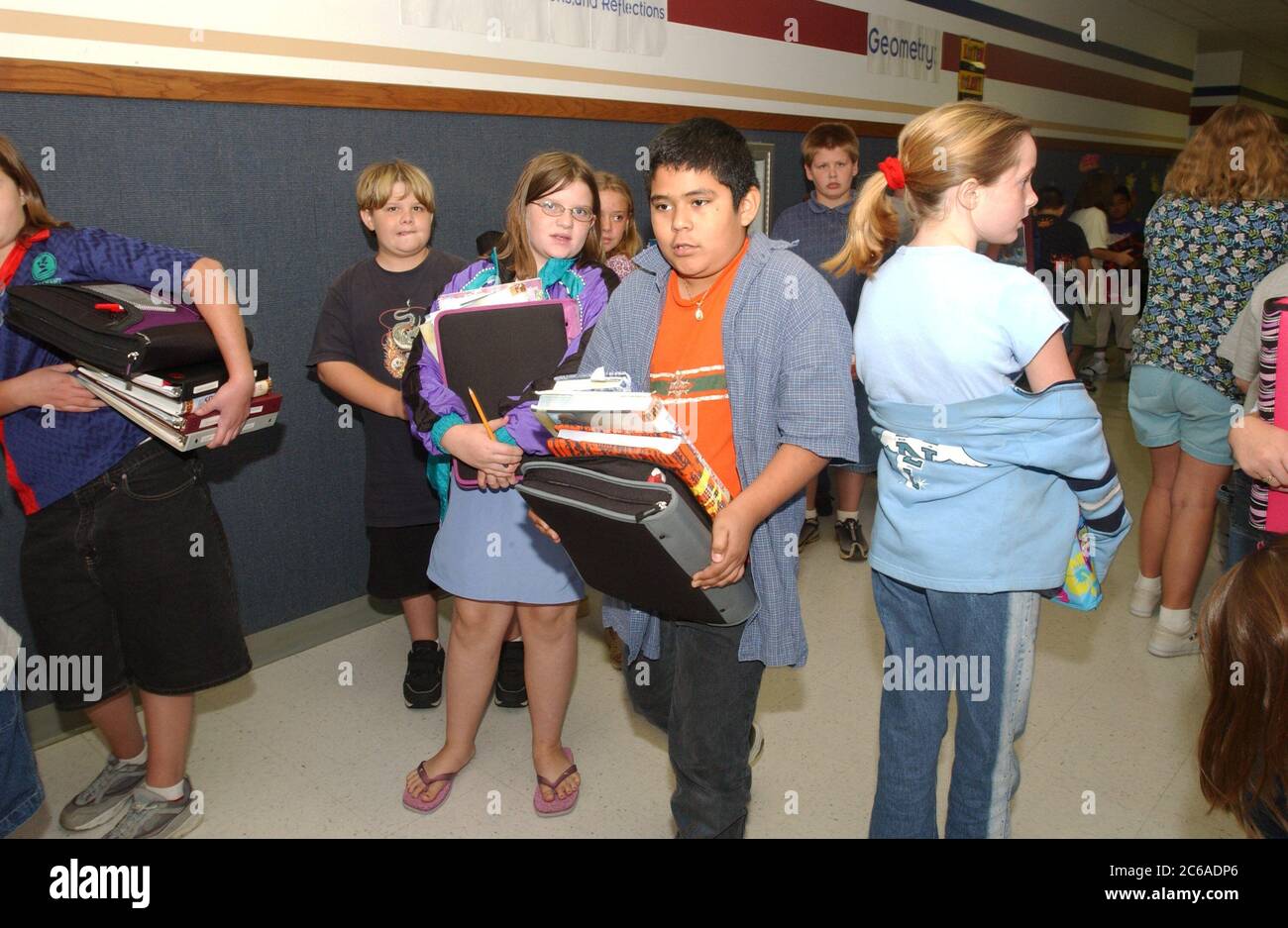 Gun Barrel City, Texas 9 settembre 2003: Gli studenti della quinta elementare lottano con un sacco di libri e materiale didattico tra le classi. Gli zaini sono usati solo in homeroom a causa di problemi di spazio nelle aule di quinta elementare. ©Bob Daemmrich Foto Stock