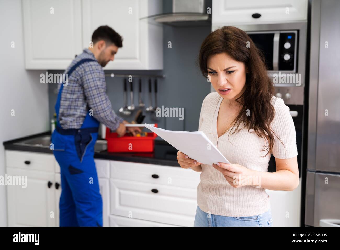 Donna cliente con fattura di riparazioni costose a casa Foto Stock