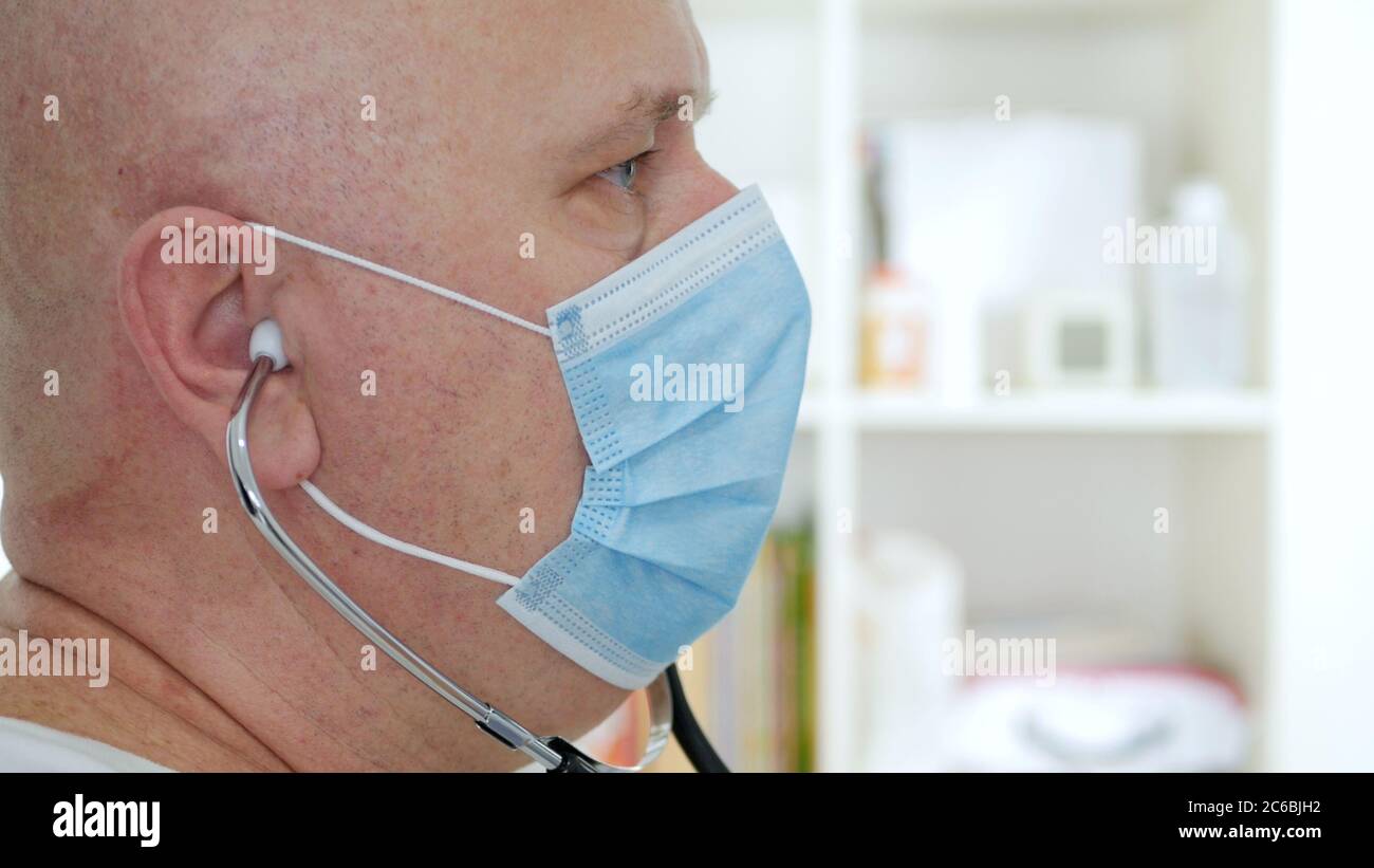 Medico che indossa maschera protettiva per il viso, persona medica con dispositivi di protezione in un ospedale in quarantena contro la pandemia COVID-19 Foto Stock