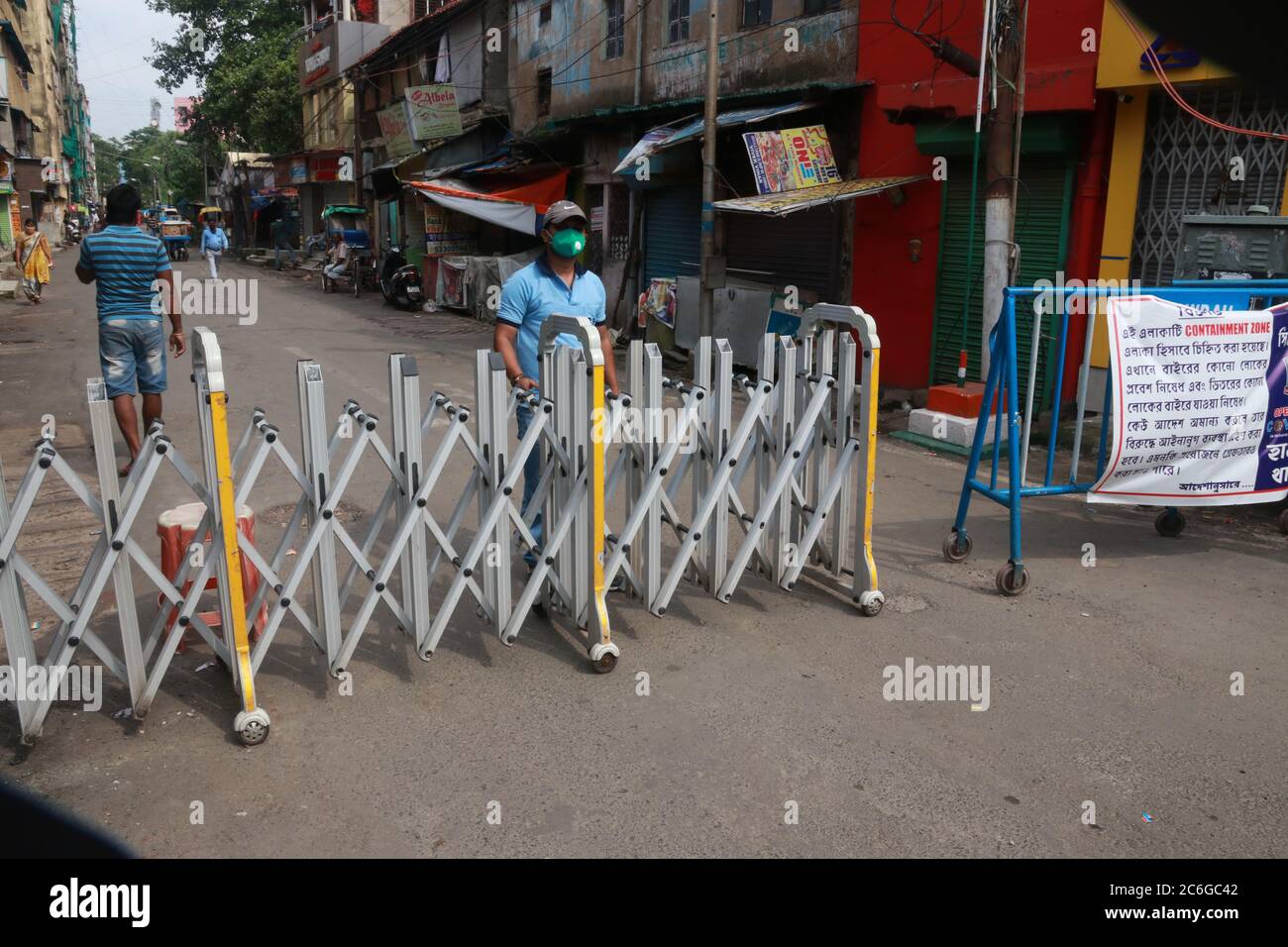 Kolkata, India. 8 luglio 2020. I poliziotti che indossano maschere di protezione contro il coronavirus tengono la veglia lungo una strada barricata dichiarata come zona di contenimento a Howrah, India, giovedì 9 luglio 2020. (Foto di Dipa Chakraborty/Pacific Press) Credit: Pacific Press Agency/Alamy Live News Foto Stock