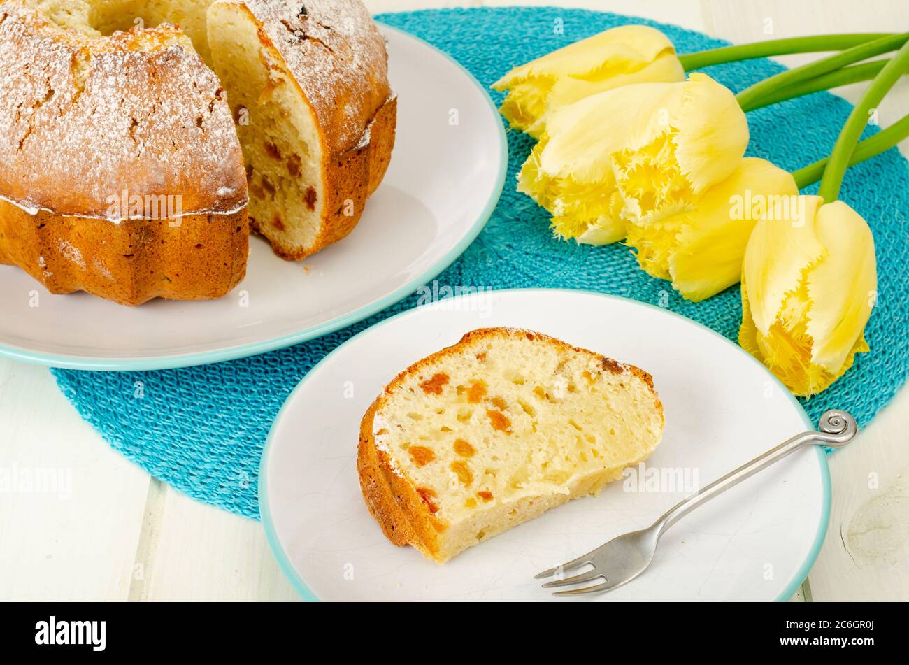 Torte fatte in casa, tulipani gialli su tavola di legno bianco. Foto Stock