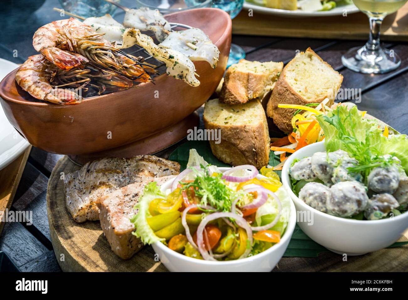 Piatti tradizionali balinesi di mare con insalata e pane a Bali, Indonesia Foto Stock