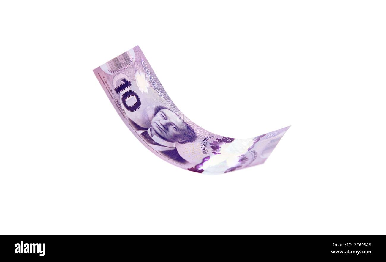 Vancouver, Canada: 23 marzo 2019: Le fatture del dollaro canadese presentate come volanti nell'aria, isolate su sfondo bianco Foto Stock