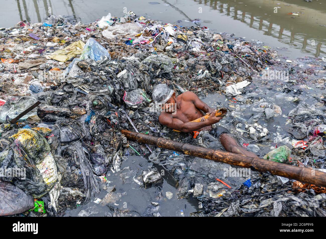 Dhaka, Dhaka, Bangladesh. 11 Luglio 2020. Un lavoratore di Volontario ripulire le rive del fiume che circondano il canale, era un canale prima ma il deposito continuo di rifiuti urbani lo rende una terra a Savar vicino Dhaka, Bangladesh il 11 luglio 2020. Credit: Zabed Hasnain Chowdhury/ZUMA Wire/Alamy Live News Foto Stock