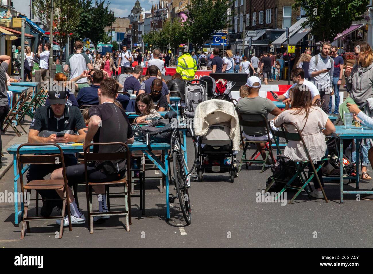 Luglio 2020, con le leggi di blocco rilassato, Northcote Road a Clapham è pedonale per consentire ristoranti e bar di mettere tavoli in strada per i clienti Foto Stock