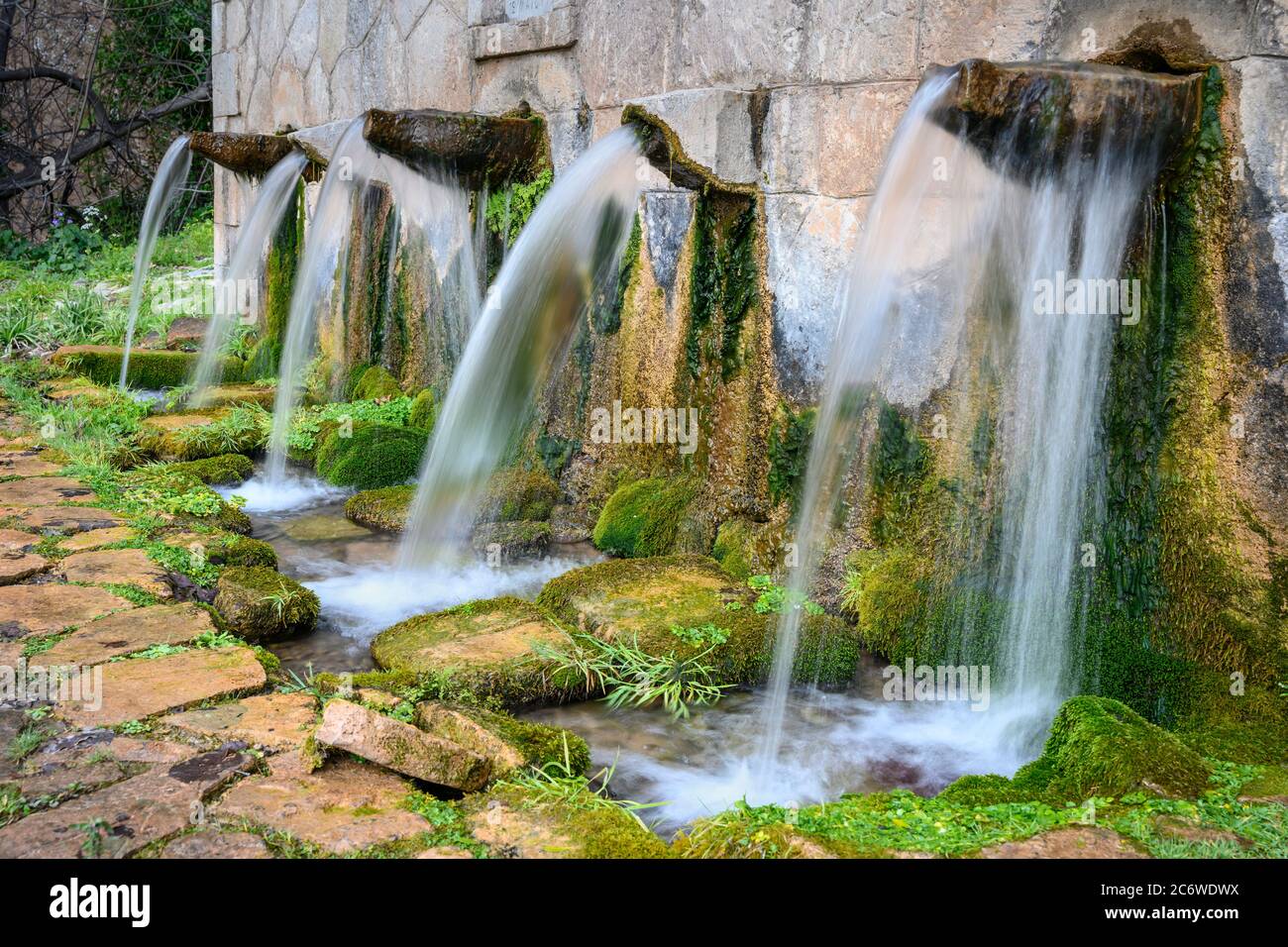 L'acqua che sgorga dalla sorgente di Koubes nel villaggio di Kato Melpeia, Messinia nord-occidentale, Peloponneso, Grecia Foto Stock