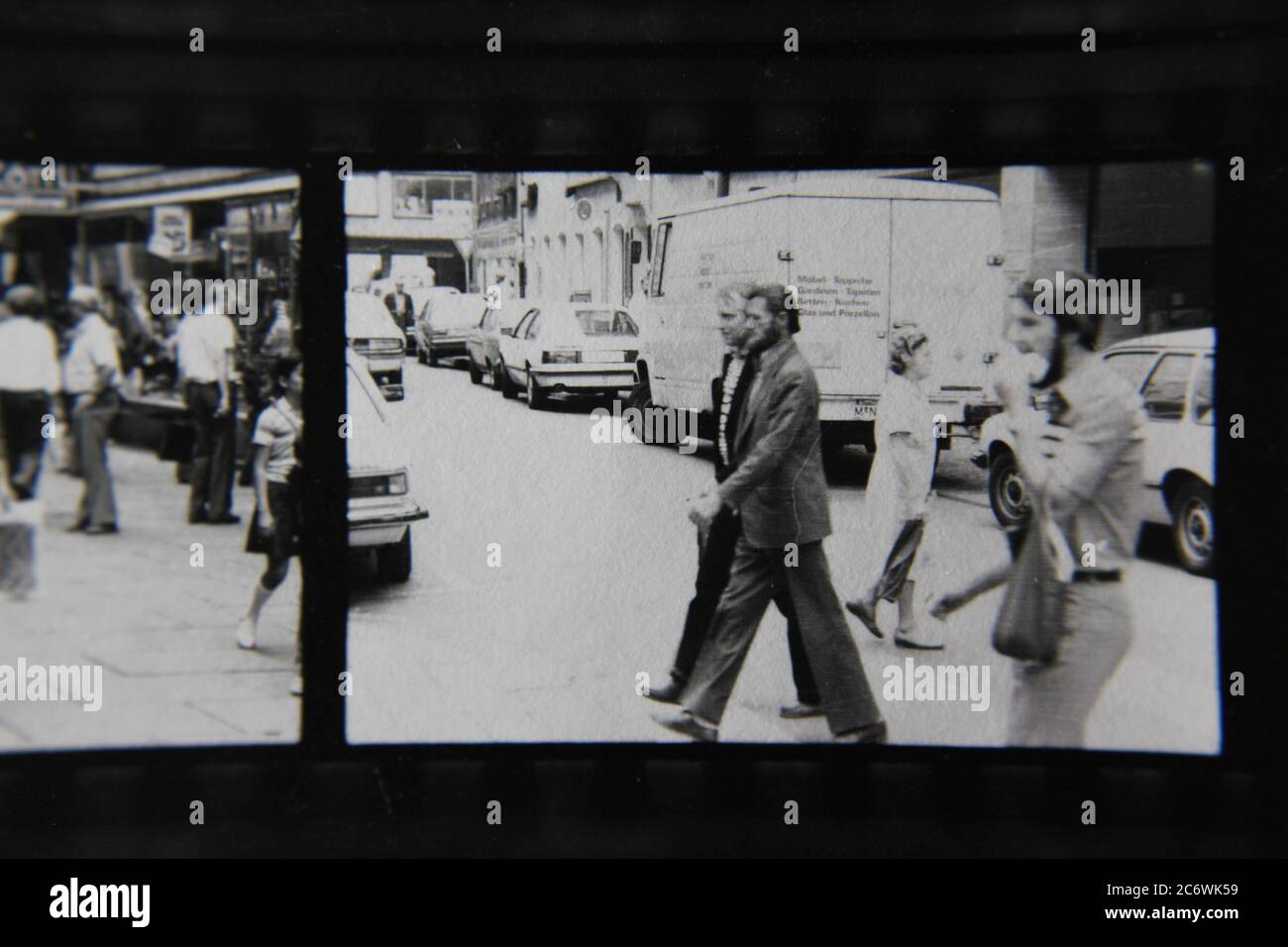 Bella fotografia di stile di vita in bianco e nero anni '70 di un uomo medio che cammina per la strada. Foto Stock