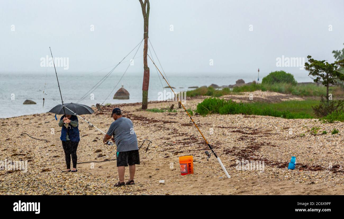 Persone che pescano sotto la pioggia su Shelter Island, NY Foto Stock