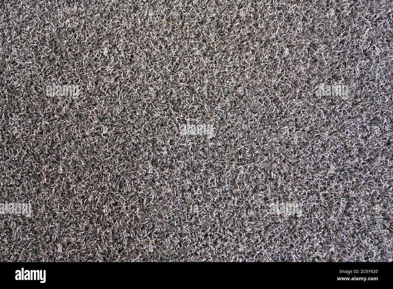 Il tappetino è realizzato in PVC plastico miscelato con gomma sintetica. Tessuto morbido, simile a una spugna, di colore grigio scuro. Foto Stock
