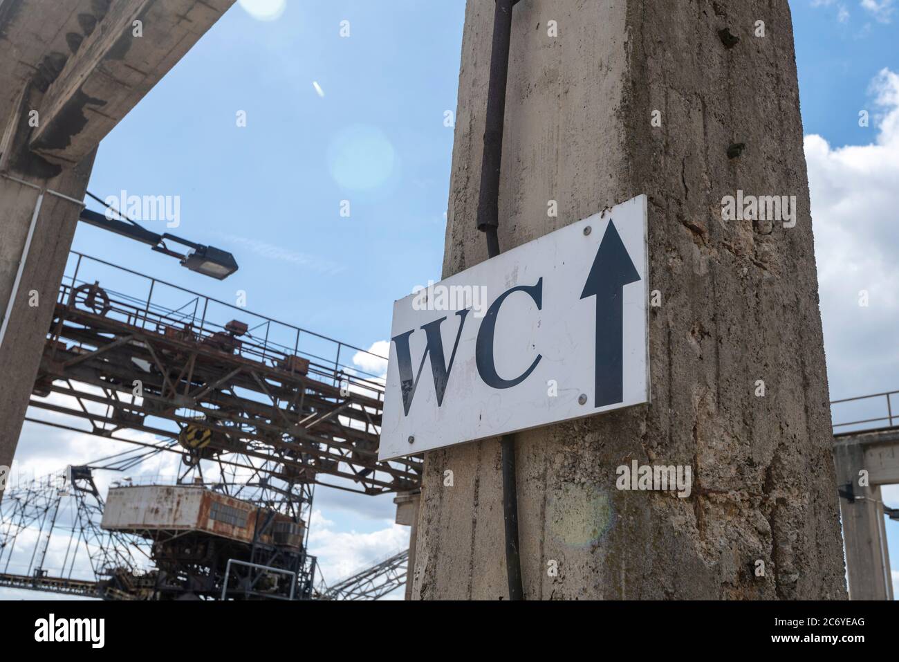 07 luglio 2020, Sassonia-Anhalt, Gräfenhainichen: Un cartello in Ferropolis mostra la strada per i servizi igienici. A causa della crisi di Corona non ci saranno grandi festival quest'anno. Affinché l'estate non venga completamente persa per gli operatori, i campeggiatori sono ora autorizzati ad accamparsi sotto gli escavatori. Foto: Stephan Schulz/dpa-Zentralbild/ZB Foto Stock