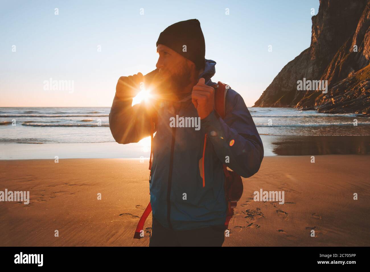 Uomo che cammina sulla spiaggia godendo tramonto vista oceano viaggio vacanze turismo sostenibile all'aperto sano stile di vita estiva vibes Foto Stock