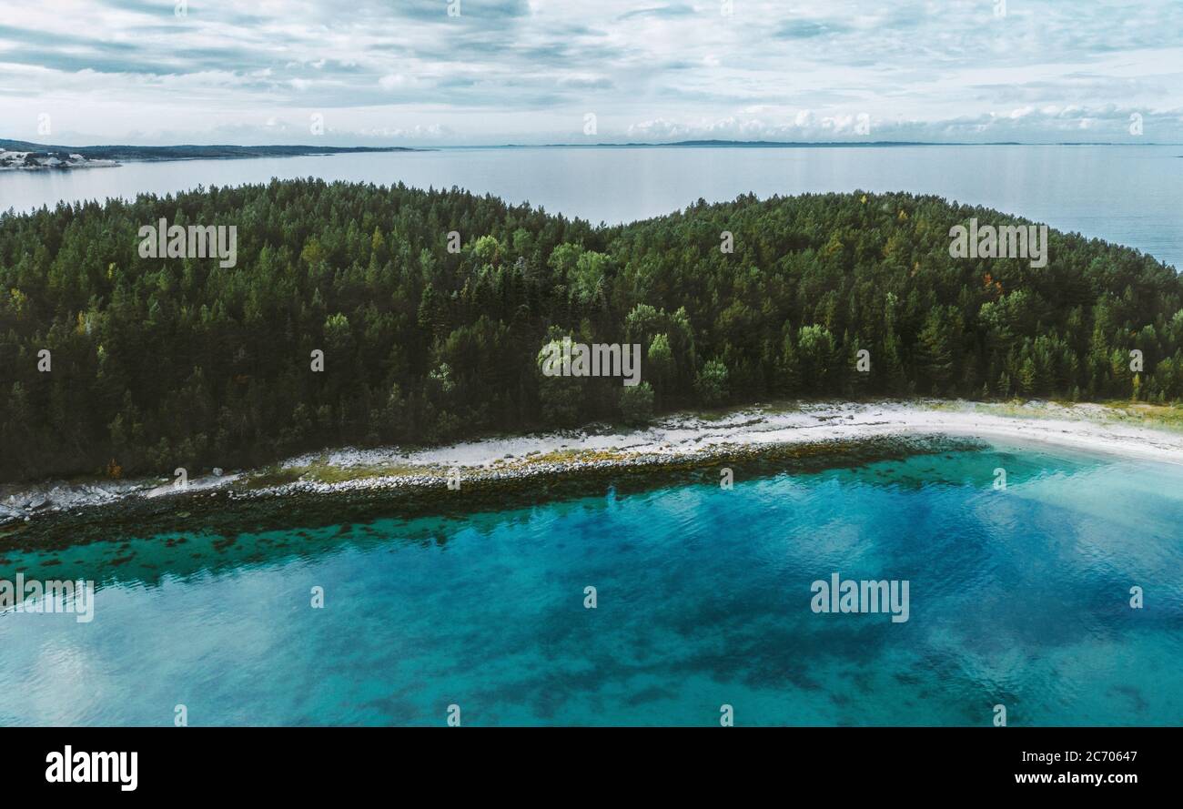 Vista aerea oceano e isola disabitata con foresta di conifere drone paesaggio natura viaggio in Norvegia turchese mare acqua scandinava natura trenino Foto Stock