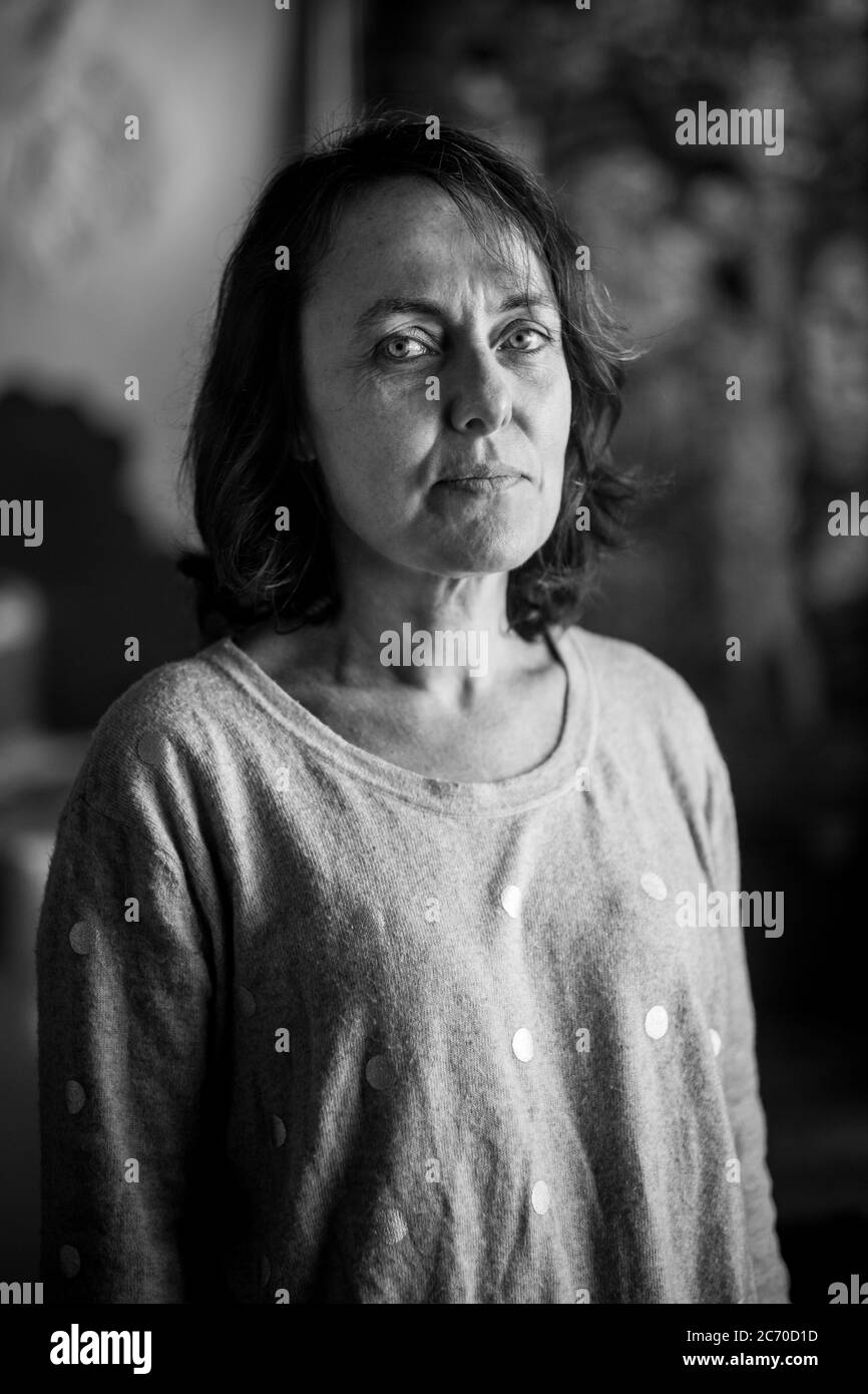 Ritratto di Catarina Bonet, 48 anni, nella sua casa paterna a Riudaura, Spagna (Catalogna). Data: 28/10/2017. Foto: Xabier Mikel Laburu. Originariamente da Barcellona, è venuta in vacanza a Riudaura da quando era una bambina quando suo padre ha comprato una casa nel villaggio. È stata l'ultimo mese che vive a Riudaura. Anche se si sente catalano, riconosce il suo sé come unionista, ma riconosce che l'ambiente le ha trasmesso una certa volontà di indipendenza. Foto Stock