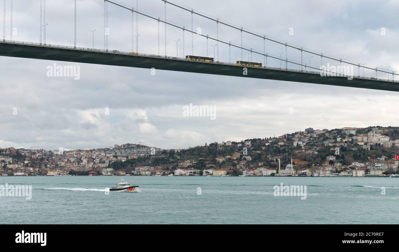 Istanbul, Turchia - Ottobre 2018: Nave di guardia costiera nello stretto di bosforo che naviga sotto il Ponte dei Martiri del 15 Luglio Foto Stock