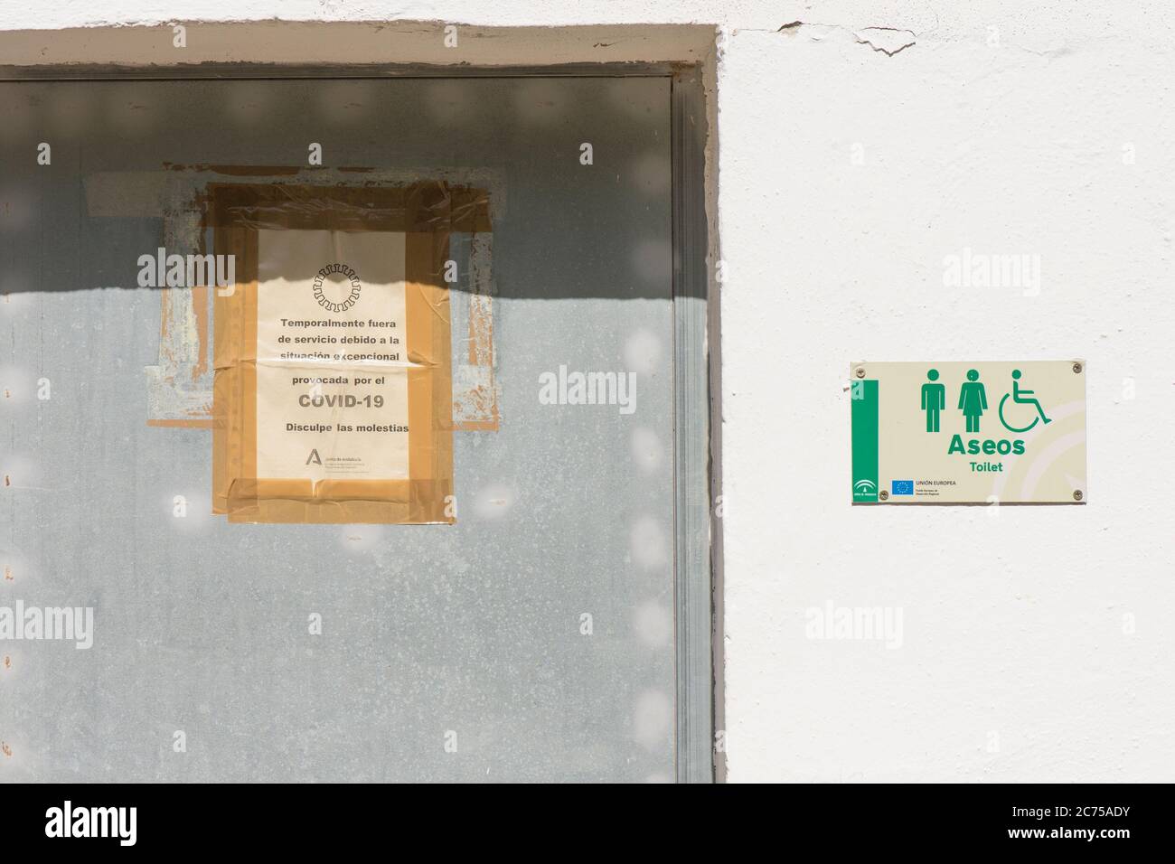 Cartello sulla porta dei servizi igienici pubblici nelle montagne del parco naturale di Malaga, chiuso a causa della pandemia globale Covid-19. Spagna. Foto Stock